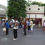 Outdoor band performance with drummers and audience.