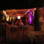 People gather at a dimly lit bar.