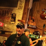 Man playing saxophone in a bar.