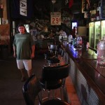 Man in bar with a jug of water.