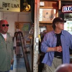 Two men in bar with Bud Light sign.