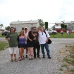 Group of friends posing in front of buildings.