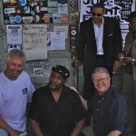 Four men and a woman pose for a photo.