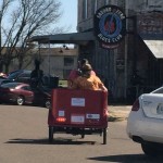 A red tricycle in front of Ground Zero Blues Club.