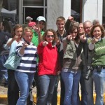 Group of friends smiling and pointing at the camera.