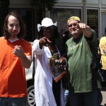 Three men and a woman standing outside a store.