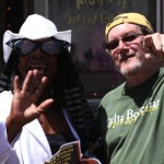 Two people, one wearing sunglasses and a hat.