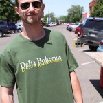 Man wearing green "Delta Bohemian" shirt.