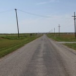 Empty rural road with power lines.