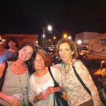 Three women smiling for a night out.