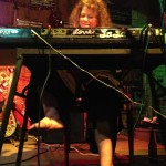 Woman playing keyboard with "Lone Star" written on it.