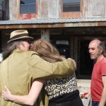 Man and woman hugging outside a building.