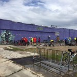 Purple building with people and bikes.