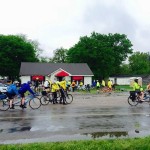 Cyclists gather outside a cafe.