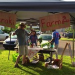 People shopping at a farm stand.