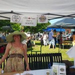 Woman at farmers market info booth.