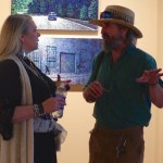 Two people discussing art in a gallery.