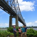 Group of people under a bridge.