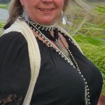 Woman wearing a black shirt and necklace.