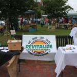 Revitalize Clarksdale event table with shirts.