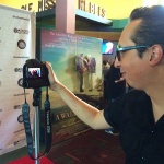 Man with camera at film festival event.