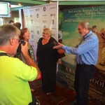 Man taking a photo at a movie premiere.