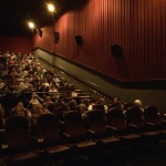 Audience in a movie theater with seats.