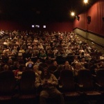 Audience watching a movie in a theater.