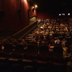 People seated in a movie theater.