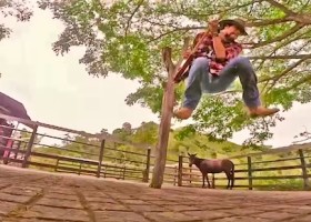 Man swinging on a rope with a donkey.