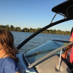 Two people in a boat on a lake.