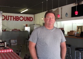 Man standing in a restaurant called Southbound.