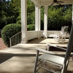 White rocking chair on a porch.