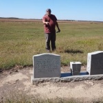 Man standing by historical marker.