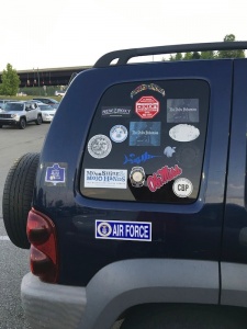 Blue car with many stickers and Air Force logo.