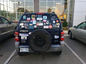 Blue Jeep covered in stickers.