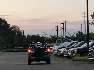 Black SUV with stickers in a parking lot.