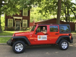 Red Jeep with tour company logo.