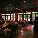 People dine in a dimly lit restaurant.