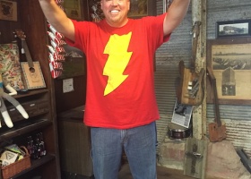 Man in red shirt with yellow lightning bolt.