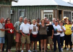 Group of people gathered outside a house.