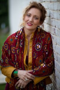 Woman in a red embroidered shawl.