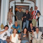 Group of people standing and sitting on porch