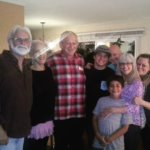 Group photo of a family inside a home.