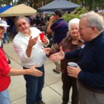 Group of people gathered, some holding red cups.