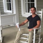 Man sitting on a porch rocking chair.