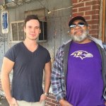 Two men standing outside a building.