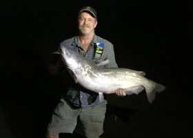 Wild Bill Briscoe shows his huge blue catfish to Dana Starkell and his group traveling the Mississippi River.