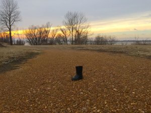 A lone boot next to the Mississippi River.