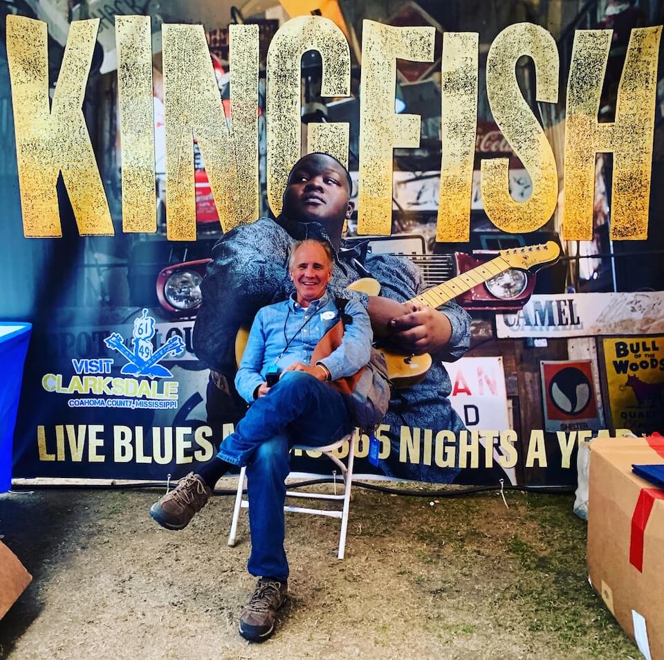 Clarksdale Tourism Executive Director Bubba O'Keefe in front of the cover of Kingfish